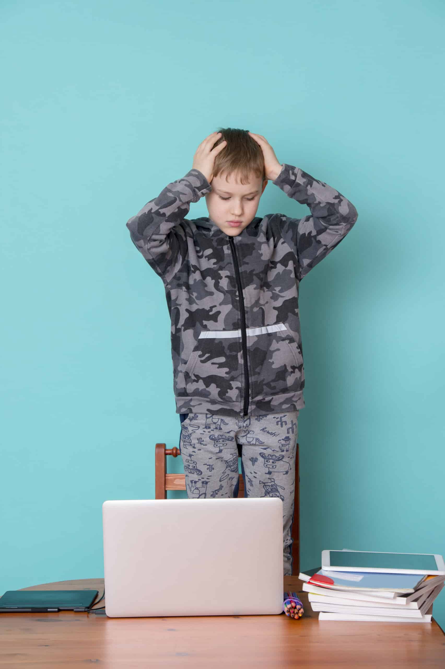 School kid using laptop while doing schoolwork at home. Homeschooling. School from home.