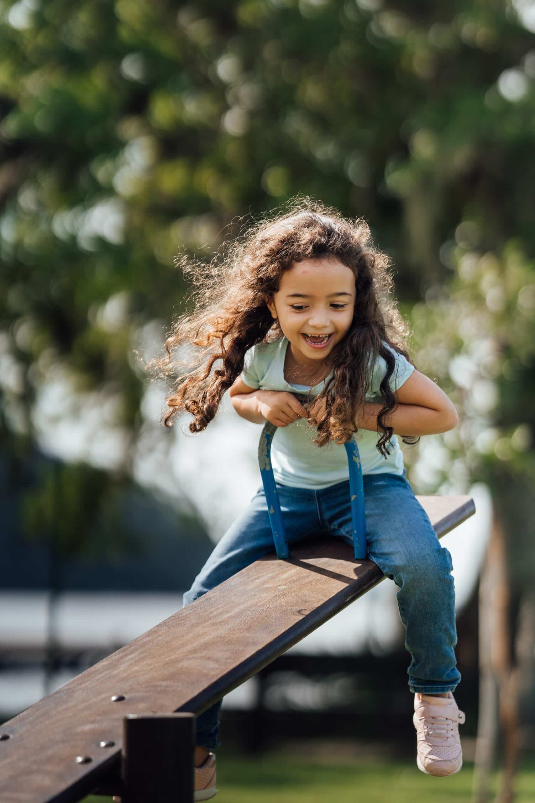 Girl having fun on the seesaw