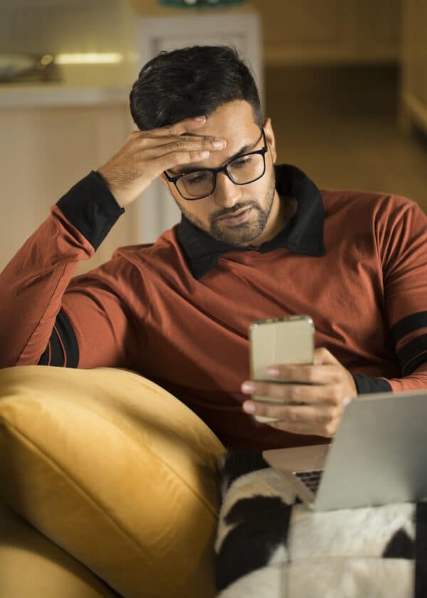 Man feeling depressed on receiving bad news using phone